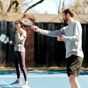 Two Pickleball players on the Pickleball court with their Pickleball gear