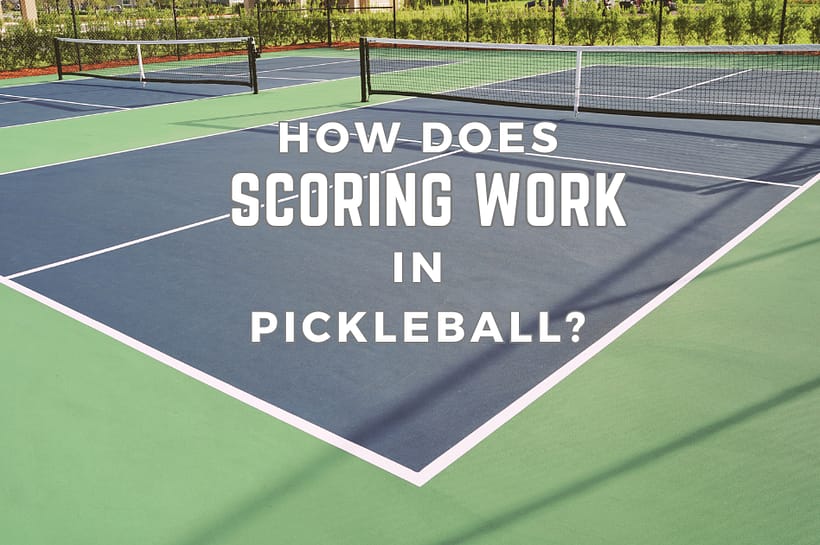 How Does Scoring Work In Pickleball? A Pickleball court in the background with blue service blocks.